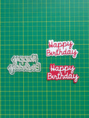 Two 'Happy Birthday' cutouts on a green grid background