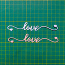 Decorative cutout letters spelling 'love' on a grid background
