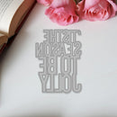 Metallic bookmark with text on a white surface with pink roses
