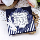 Navy blue card with white text and design elements on a decorative surface.