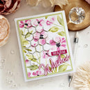 Greeting card with floral design and 'Warm Wishes' text on a decorative surface.