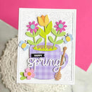 Card with spring-themed design featuring flowers and a mug on a pink background