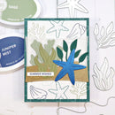 Card with starfish design and 'Summer Wishes' text, surrounded by ink pads and stamp outlines.