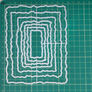Set of white cutting dies on a green grid background