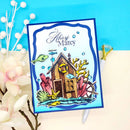 Colorful card with a nautical design featuring a cabin, fish, and coral on a blue background.