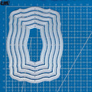 Set of layered cutting dies on a blue grid background