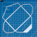 Clear geometric cutting template on a blue grid cutting mat