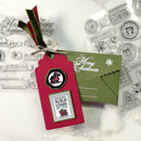 Christmas-themed card with red envelope and green card on a white background with stamps.