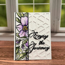 Greeting card with floral design and 'Enjoy the Journey' text on a wooden surface.