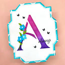 Decorative letter 'A' with flowers and butterflies on a pink background