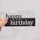 Clear acrylic block with 'happy birthday' text held by a hand against a light background