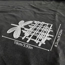 Metallic dragonfly and grid design with measurements on a black fabric background