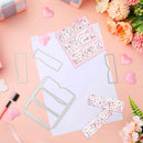 Decorative paper cutouts with floral patterns on a pink surface with flowers and stationery items.