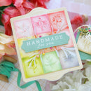 Handmade card with decorative elements on a floral background
