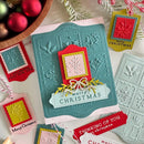 Christmas card with embossed design and decorative tags on a white surface.