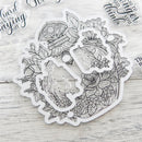 Clear stamp set with floral and nature-themed designs on a wooden surface.