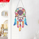Colorful dreamcatcher with feathers hanging on a white wall.