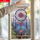 Colorful dreamcatcher decoration hanging by a window