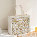 Decorative glass block with gold mandala pattern on a white background