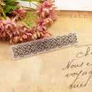 Decorative metal bookmark on an old letter with pink flowers