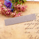 Decorative stencil with leaf pattern on a textured surface with flowers