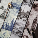 Set of bookmarks with vintage cityscape designs and two pens on a textured surface.
