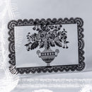 Decorative black lace tablecloth with floral design on a white background