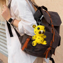 Brown backpack with a yellow crochet tiger keychain attached