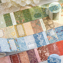 Collection of floral patterned paper sheets with a roll of paper in the background.
