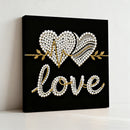 Decorative wall art with heart shapes and 'love' text on a black background