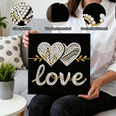 Person holding a decorative wall art with pearl embellishments and text 'love'.
