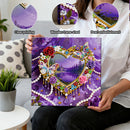 Person holding a decorative painting with heart design, flowers, and butterfly on a purple background.