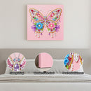Decorative butterfly wall art with colorful embellishments on a pink background.