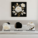 Decorative wall art with floral design on a black background, displayed above a sofa.