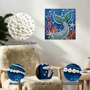 Decorative art piece with mermaid design and pearl embellishments, surrounded by pearls of different sizes and close-up shots.