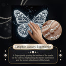 Canvas with butterfly design, hand touching it, and close-up of pearls on dark background
