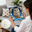 Woman holding a DIY decorative pearl painting kit with an owl design, surrounded by pearls of different sizes.