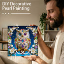 Man holding a completed DIY decorative pearl painting of an owl