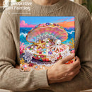 Person holding a completed DIY decorative pearl painting with a colorful shell and octopus design.