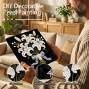 Person holding a decorative pearl painting with a living room background