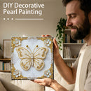 Man holding a DIY decorative pearl painting of a butterfly