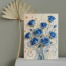 Decorative wall art with blue roses and pearls on a neutral background