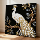 Decorative wall art of a peacock with pearls and gold accents on a black background.