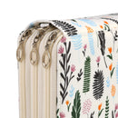 Close-up of a zippered clutch or document bag with a cream base and a botanical print featuring green, black, blue, pink, and orange leaves and flowers, shown with gold-tone metal zipper pulls.