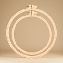 Wooden embroidery hoop on a beige background