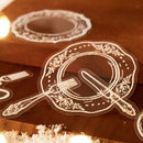 Decorative cutout of a plate with fork and knife on a wooden surface