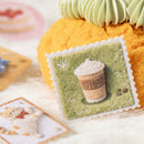 Decorative patch with a coffee cup design on a soft surface