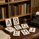 Vintage books on a shelf with typewriter and letter blocks on a desk