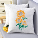 Decorative pillow with sunflower design on a gray chair