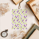Floral notebook with dried flowers and books on a light surface